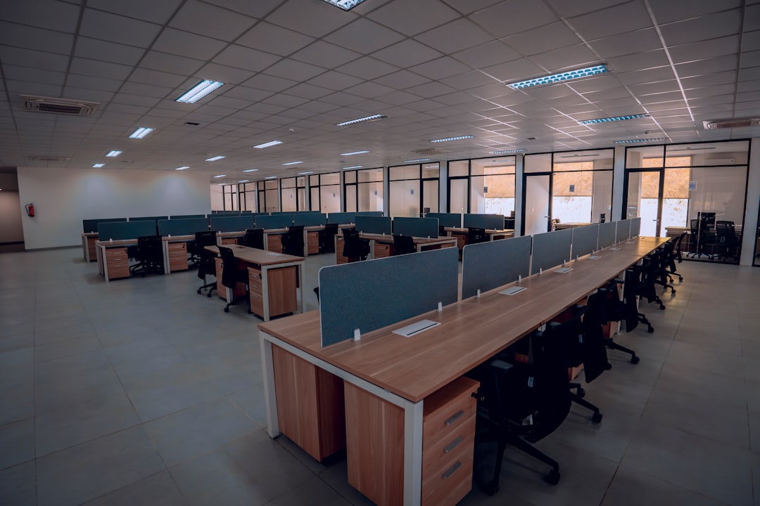 an empty office space with desks and chairs