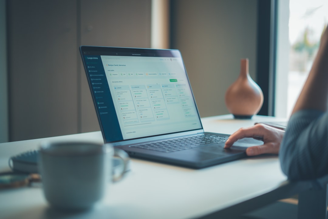 Person working on a laptop at a desk.