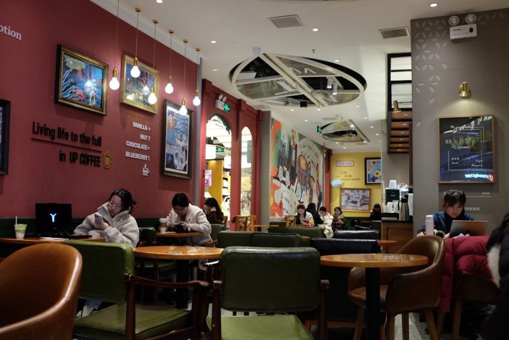 People sitting in a cozy coffee shop interior.